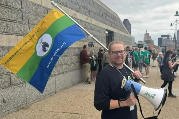 white man with red hair holding afscme flag