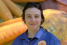 person with black hair smiling