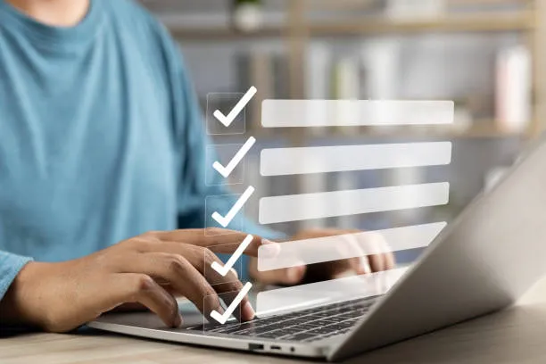 Photo of person filling out a form on a computer