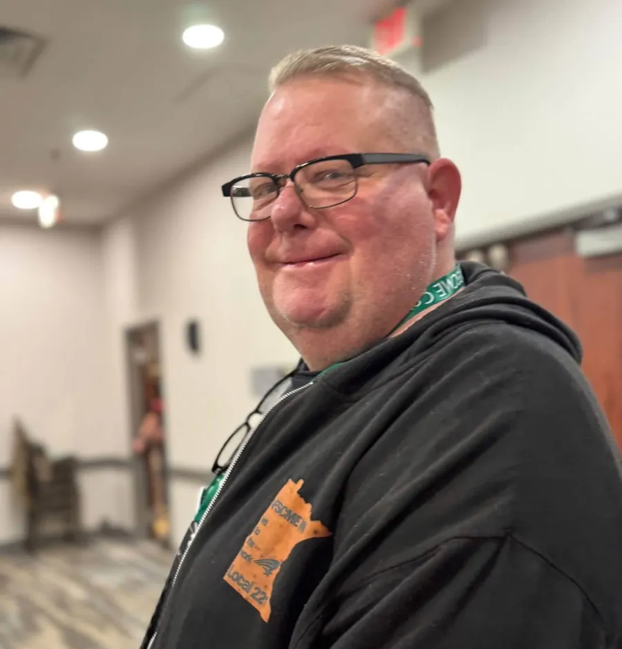 Darren Trast, Council 5 Secretary wearing a black sweatshirt with Local 221 orange logo